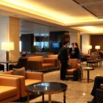 Luxury airport lounge with plush seating and elegant decor.