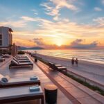 Resort de luxo com vista para o oceano e céu ao pôr do sol.