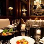 Elegant table with gourmet dishes in private dining room.