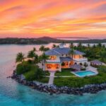 Private island villa with beach and tropical surroundings.