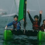 three people riding on boat