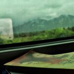 a book sitting on top of a table next to a window