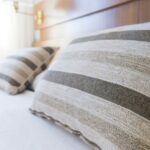 gray and black throw pillow on bed