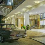 gray sedan parked beside lighted building