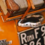 A close up of a car with luggage on the back of it
