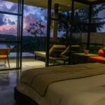 A bedroom with a large bed sitting next to a window