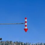 A red and white street light on a pole