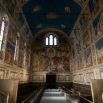 a long hallway with paintings on the walls