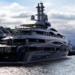 A large boat in the water next to a dock