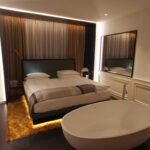 white bed near brown window curtain
