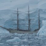 white galleon ship near glaciers