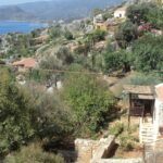 a small village on a hill overlooking a body of water