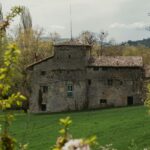 brown brick building near green grass field during daytime