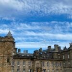 Scottish Castle Buyout with Falconry and Whisky Vault Access A majestic castle stands under a cloudy sky.
