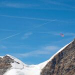 a plane flying over a snow covered mountain