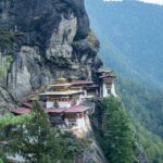 brown and white concrete house on mountain during daytime