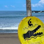 a yellow frisbee sitting on top of a sandy beach