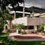 green grass lawn near brown concrete building during daytime
