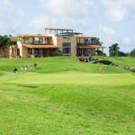 A golf course with a house in the background