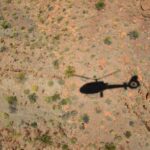 Australia Lodge Buyouts with Outback Heli and Stargazing shadow of person on gray sand during daytime