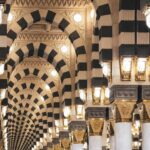 Saudi Heritage Hotels with UNESCO Access and Guides a hallway in a large building with columns and lights
