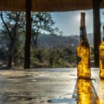 a couple of bottles of alcohol on a wooden table