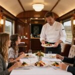 Family dining in a luxurious private train car with chef and butler.