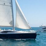 Sailing yacht and motor yacht on the water.